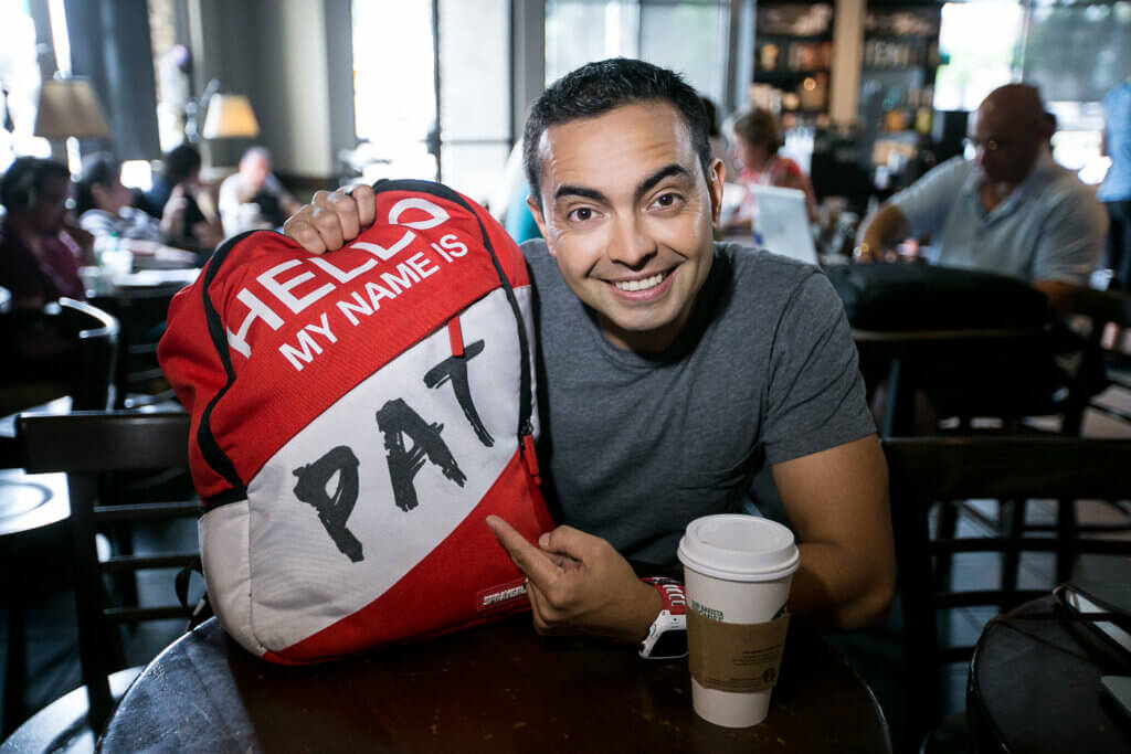 Pat Flynn with backpack that reads "Hello my name is Pat"
