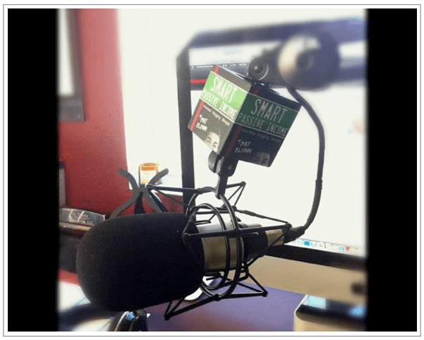 SPI Mic Flag A microphone flag, which is a box that goes on the microphone stand. On each side of the box is the SPI Podcast logo.